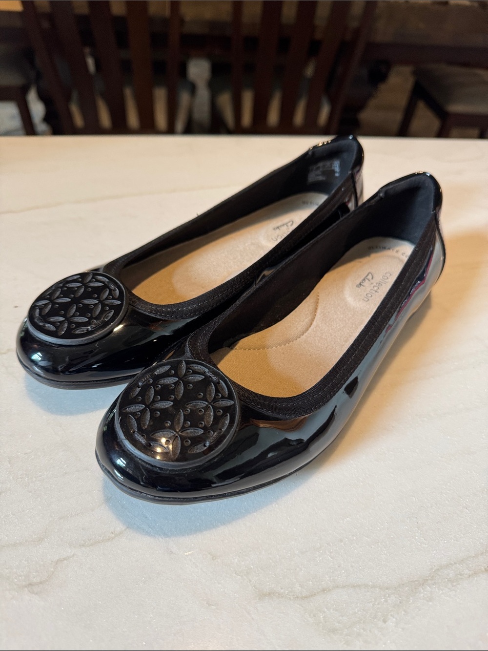 Clarks Black Patent Round-Toe Ballet Flats with Decorative Medallion